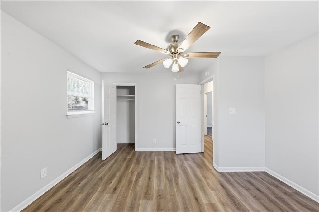 2086 Fairburn Road Southwest Atlanta, GA 30331 - Photo 20 of 28 a view of a room with wooden floor and ceiling fan