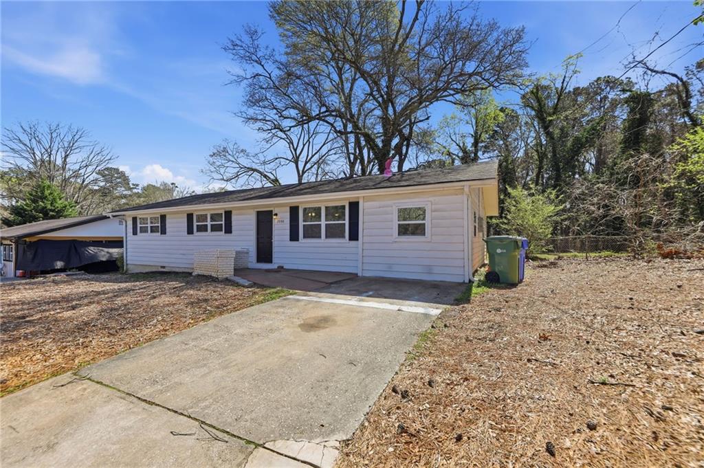 2086 Fairburn Road Southwest Atlanta, GA 30331 - Photo 2 of 28 a view of a house with a yard covered in snow