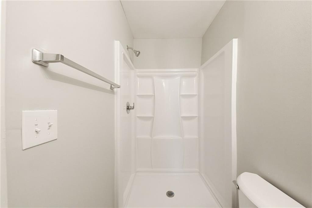 2086 Fairburn Road Southwest Atlanta, GA 30331 - Photo 22 of 28 a bathroom with a shower a toilet and a shower