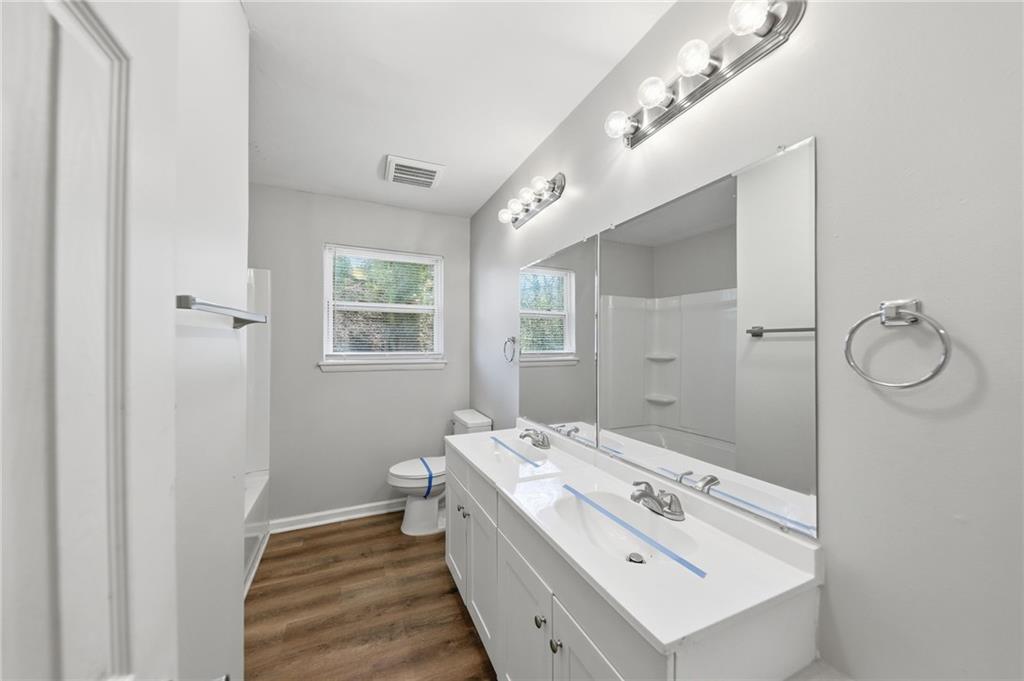 2086 Fairburn Road Southwest Atlanta, GA 30331 - Photo 23 of 28 a bathroom with a sink mirror and vanity