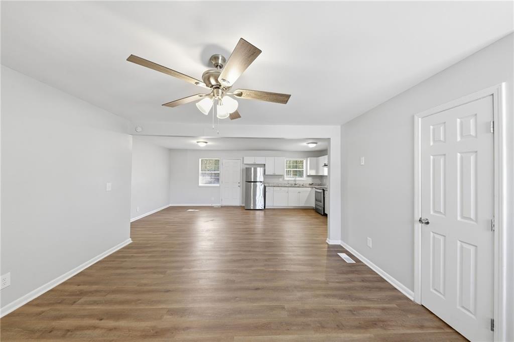 2086 Fairburn Road Southwest Atlanta, GA 30331 - Photo 6 of 28 a view of an empty room with window and wooden floor