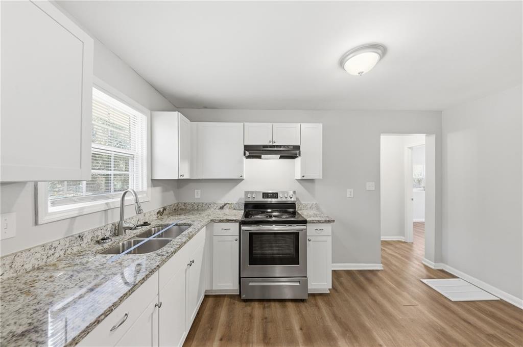 2086 Fairburn Road Southwest Atlanta, GA 30331 - Photo 10 of 28 a kitchen with stainless steel appliances granite countertop a stove and white cabinets