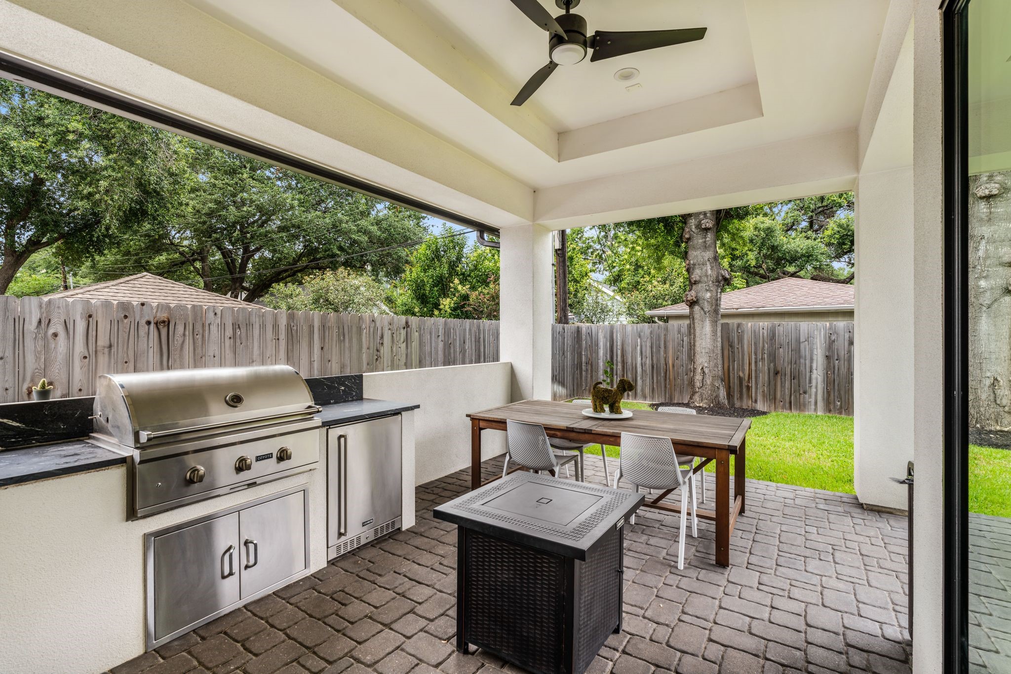 4638 Merwin Street Houston, TX 77027 - Photo 33 of 42 Step outside to a covered patio designed for year-round outdoor living and entertaining, complete with a fully equipped summer kitchen.
