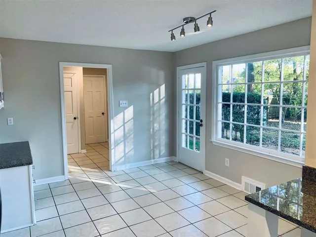 a view of an entryway with wooden floor and a window