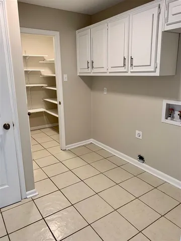 a view of a closet and wooden cabinet