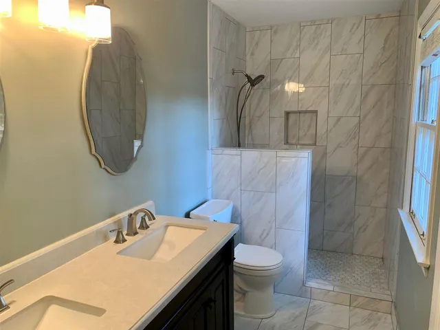 a bathroom with a sink toilet and shower