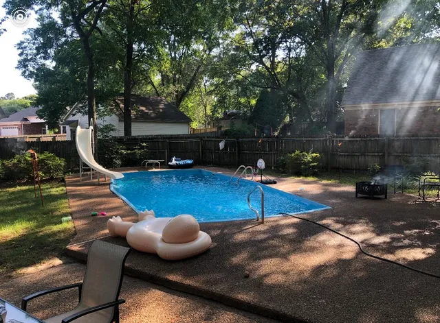 a view of a swimming pool with a patio