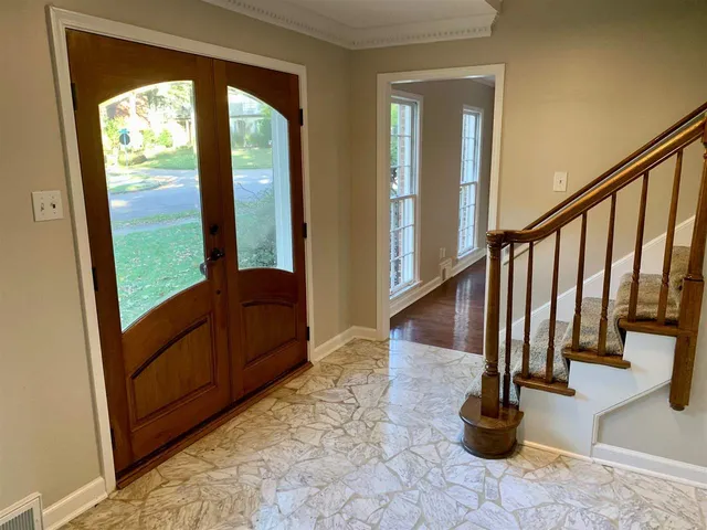 a view of a porch with wooden floor and a potted plant
