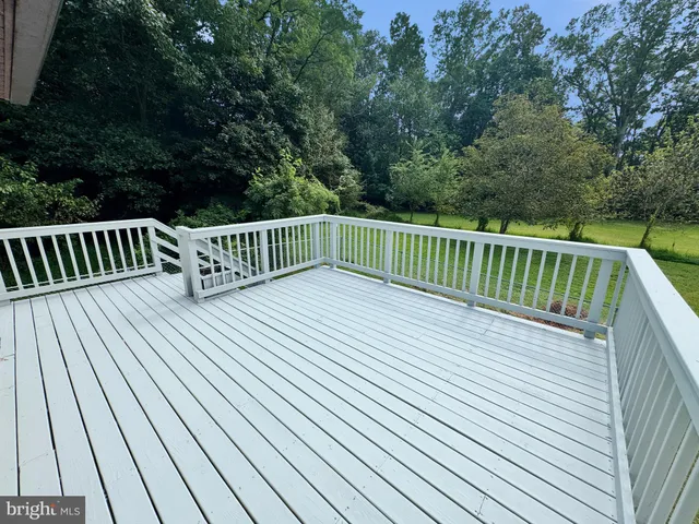a view of balcony with wooden floor and fence