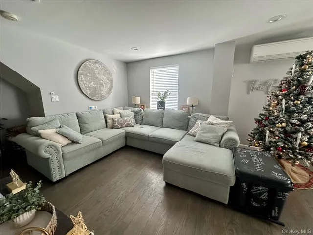 a living room with furniture and a christmas tree