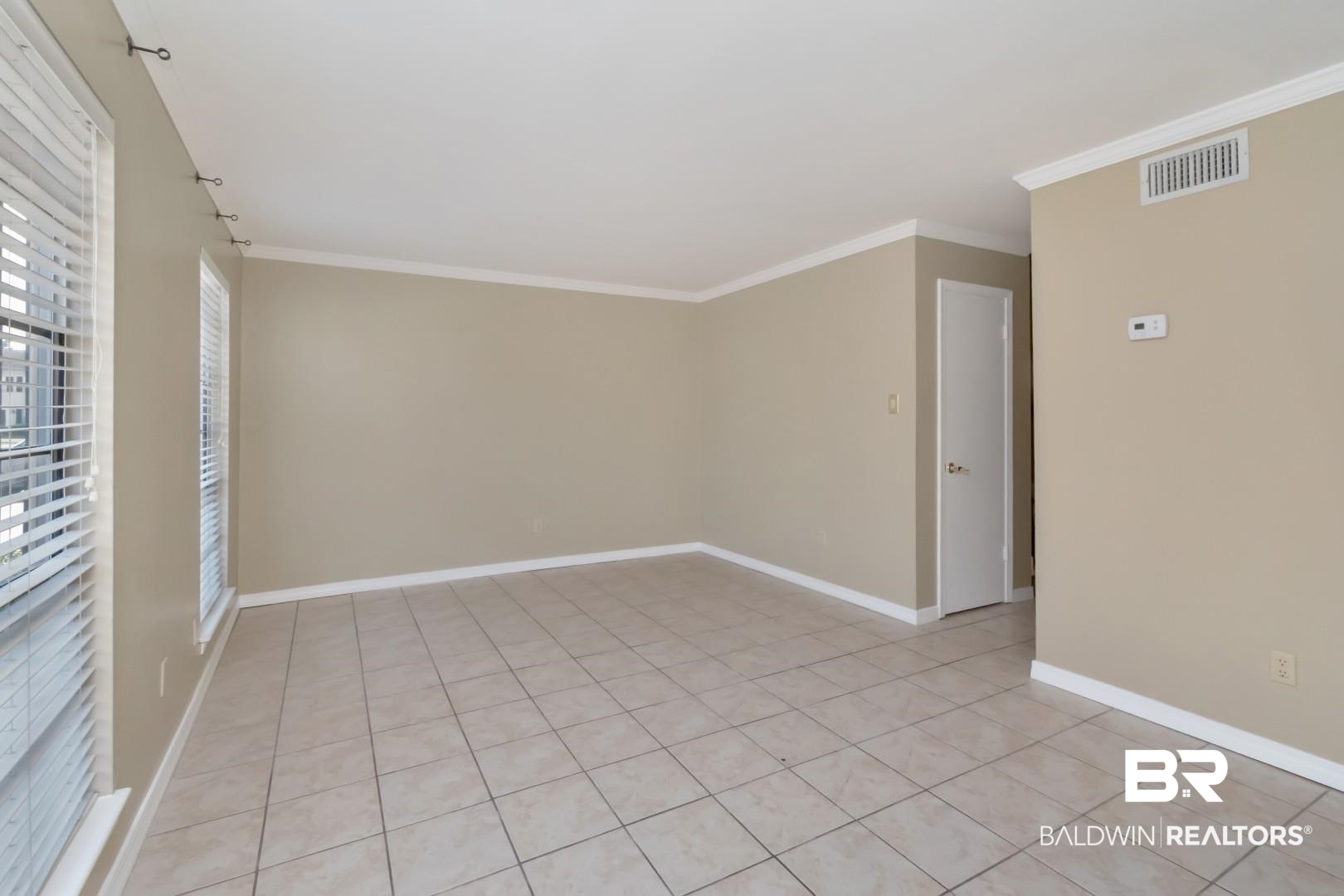 110 Du Rhu Drive, Unit E Mobile, AL 36608 - Photo 3 of 19 Unfurnished room with light tile patterned floors and crown molding