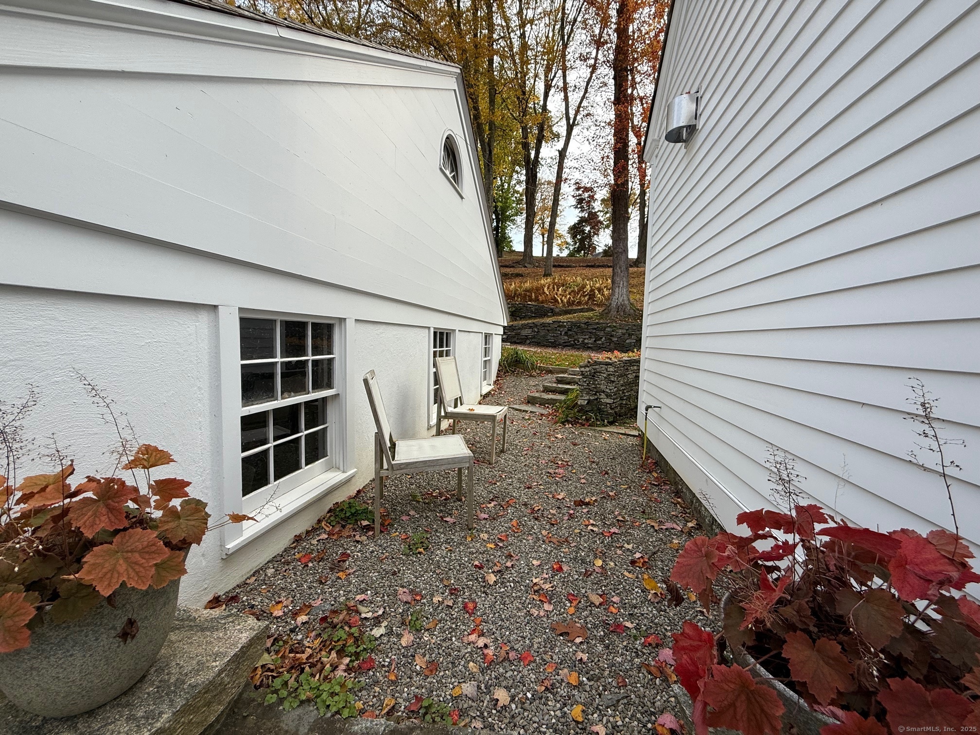 150 Ferry Road, Unit GATEHOUSE Lyme, CT 06371 - Photo 27 of 28 a view of a chair and potted plants in the back yard