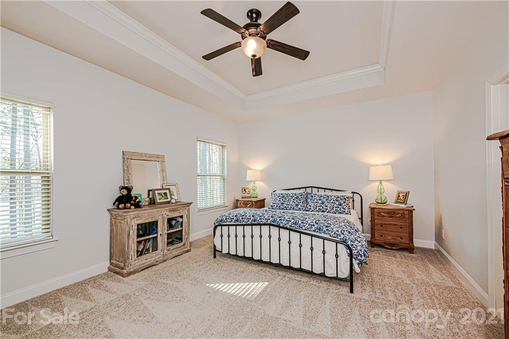 172 Streamwood Road Troutman, NC 28166 - Photo 22 of 46 a bedroom with a bed and a ceiling fan