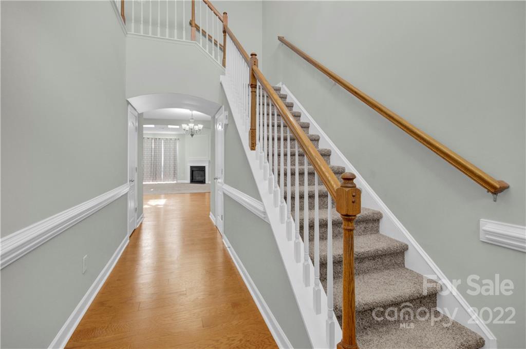 12028 Red Rust Lane Charlotte, NC 28277 - Photo 3 of 39 a view of staircase with wooden floor and white walls