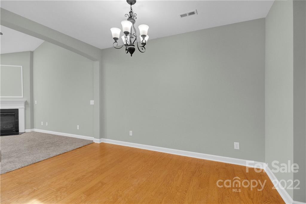 12028 Red Rust Lane Charlotte, NC 28277 - Photo 5 of 39 a view of a big room with a chandelier fan and a fireplace