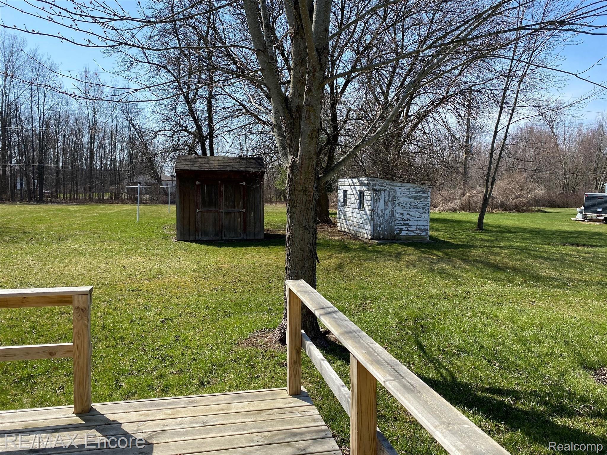 8060 Newburg Road Durand, MI 48429 - Photo 15 of 41 New small deck off of kitchen. 2 sheds included as well. Nice flat yard.
