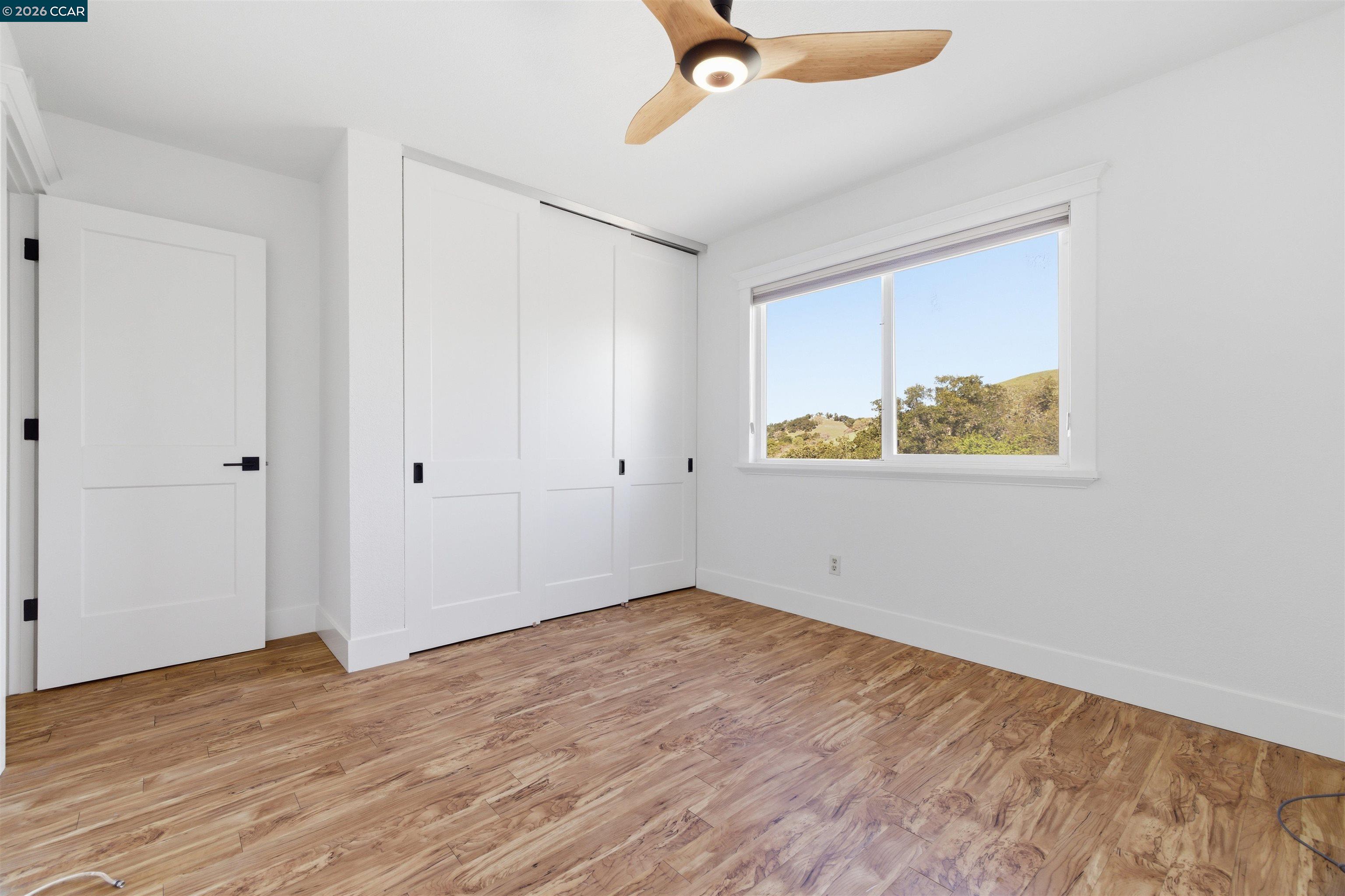 9530 Morgan Territory Road Livermore, CA 94551 - Photo 30 of 55 a view of an empty room with wooden floor and a window