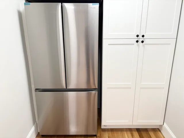 a view of closet with wooden floor