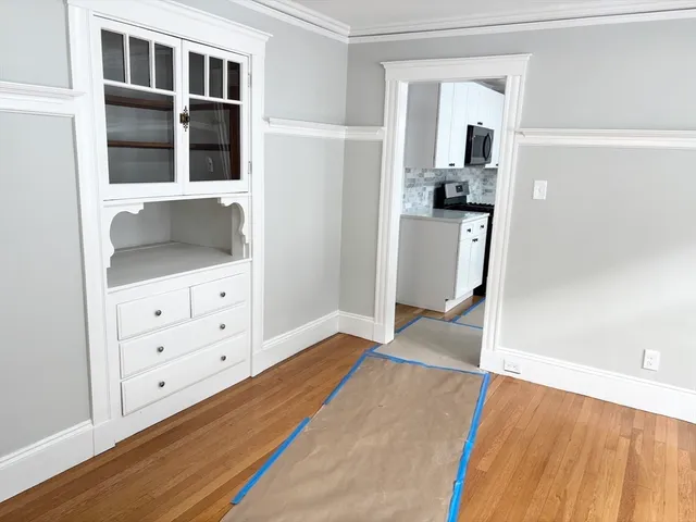 a view of a bedroom with cabinet and mirror