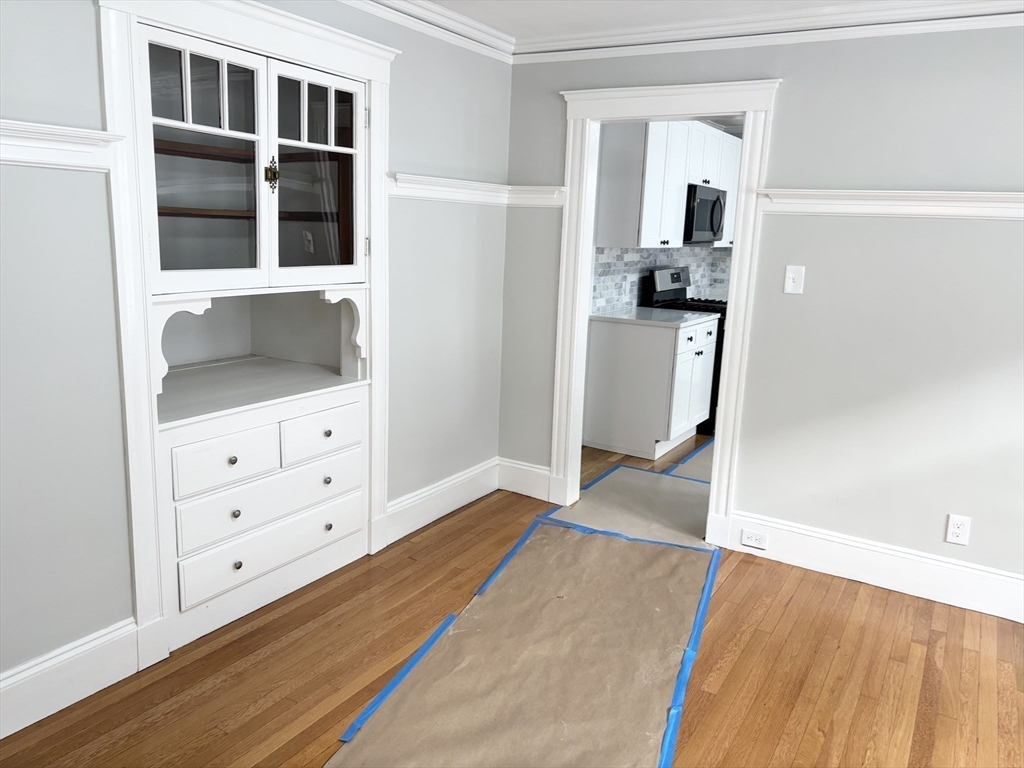 73 Dent Street, Unit 2 Boston, MA 02132 - Photo 17 of 41 a view of a bedroom with cabinet and mirror