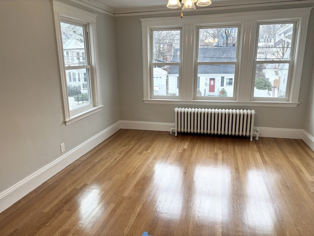 73 Dent Street, Unit 2 Boston, MA 02132 - Photo 20 of 41 a view of an empty room with wooden floor and a window