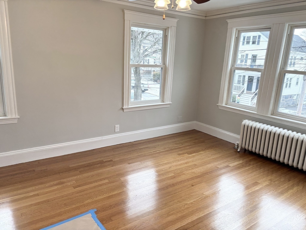 73 Dent Street, Unit 2 Boston, MA 02132 - Photo 21 of 41 a view of an empty room with wooden floor and a window