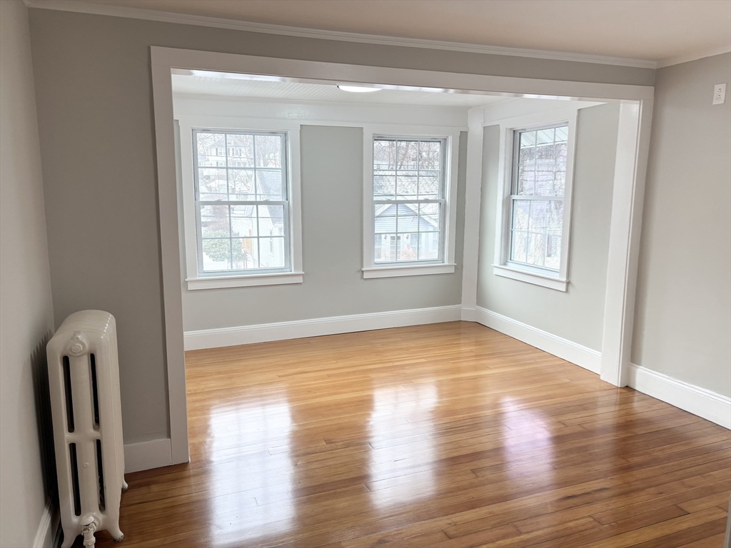 73 Dent Street, Unit 2 Boston, MA 02132 - Photo 23 of 41 a view of an empty room with wooden floor and a window