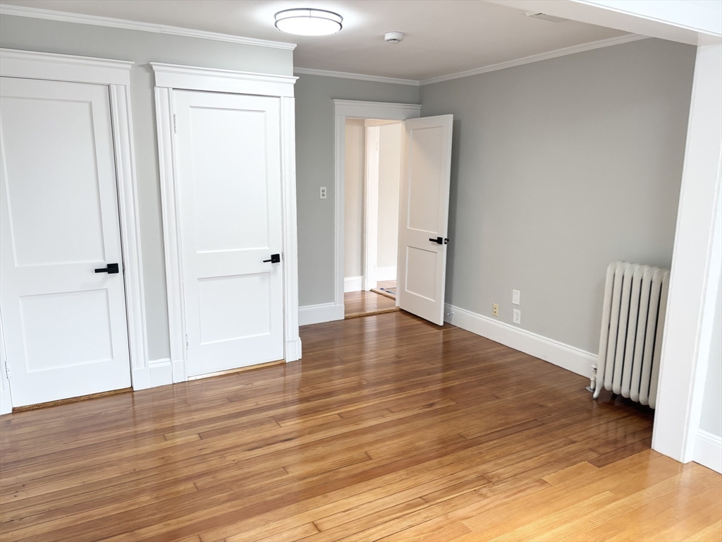 73 Dent Street, Unit 2 Boston, MA 02132 - Photo 24 of 41 a view of a hallway with wooden floor