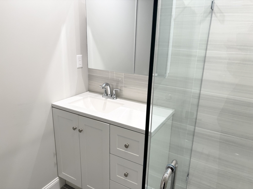 73 Dent Street, Unit 2 Boston, MA 02132 - Photo 26 of 41 a bathroom with a sink and a mirror