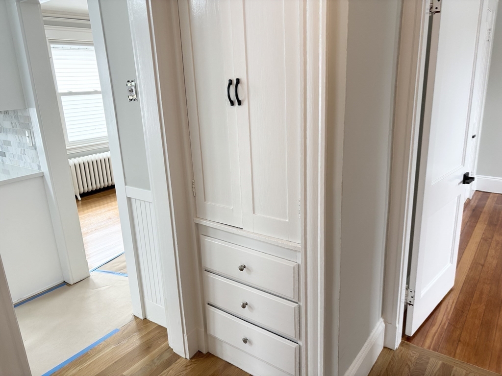 73 Dent Street, Unit 2 Boston, MA 02132 - Photo 28 of 41 a view of a hallway with wooden floor and cabinet