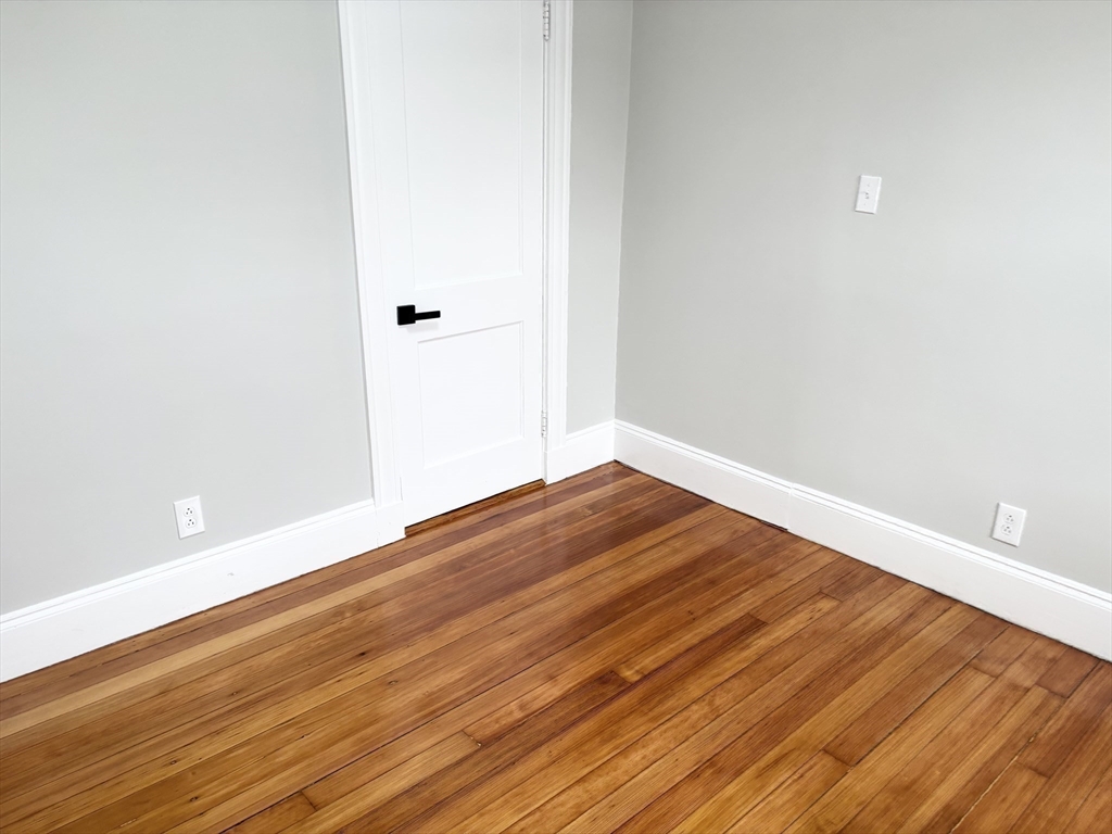 73 Dent Street, Unit 2 Boston, MA 02132 - Photo 31 of 41 a view of empty room with wooden floor