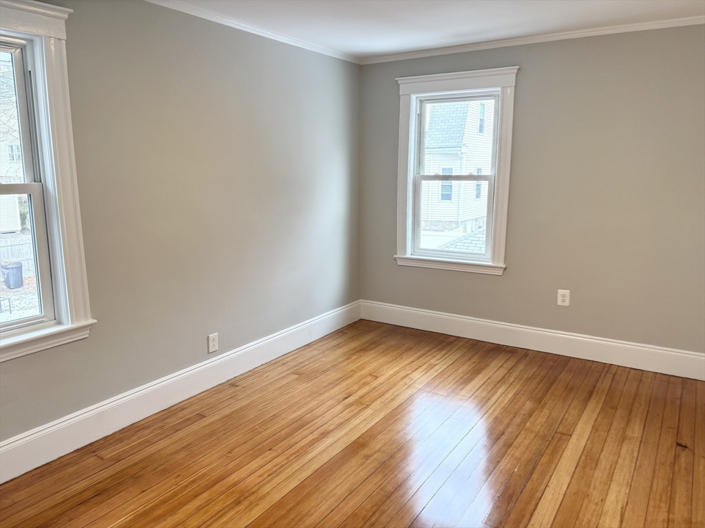 73 Dent Street, Unit 2 Boston, MA 02132 - Photo 33 of 41 a view of an empty room with wooden floor and a window