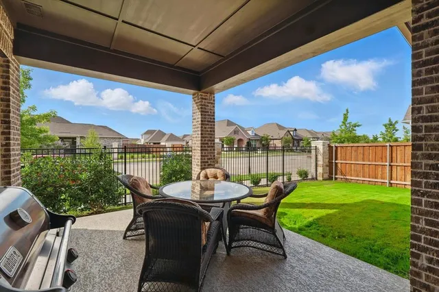 a view of a porch with furniture and garden
