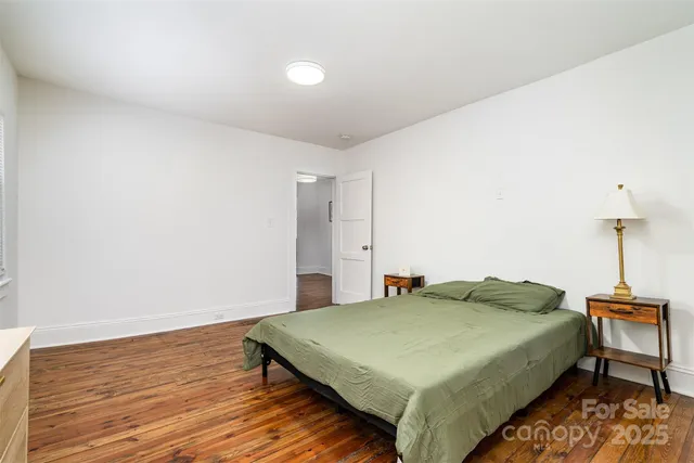 a bedroom with a bed and a table