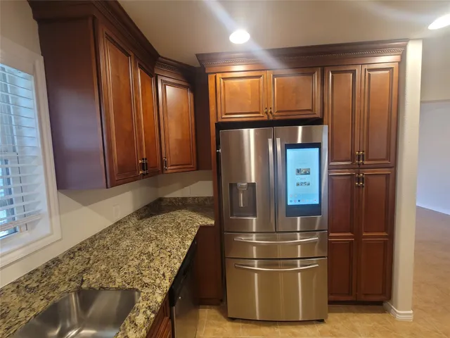 a kitchen with refrigerator and window