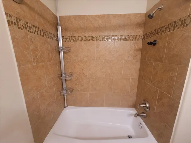 a bathroom with a shower and a tub