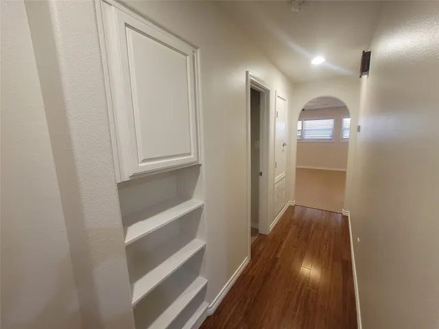 a view of a hallway with wooden floor