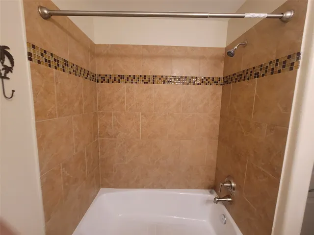 a bathroom with a shower and a shower