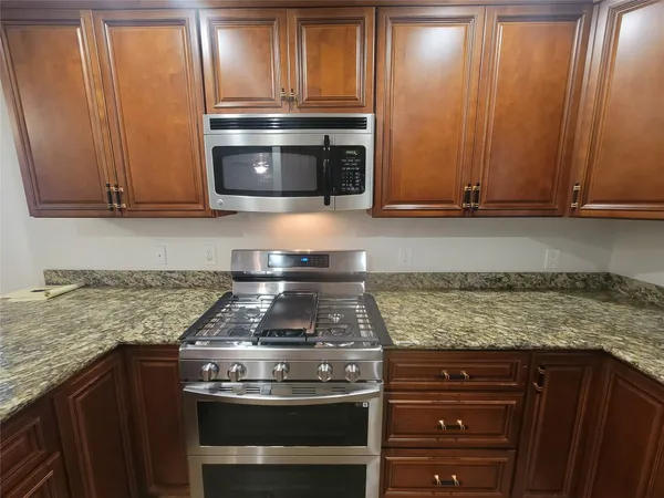 a stove top oven sitting inside of a kitchen