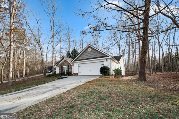 a view of a house with a large tree in front of a house