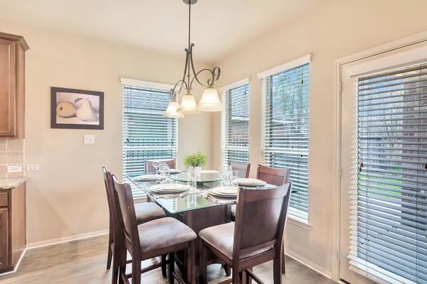 a view of a dining room with furniture window and wooden floor