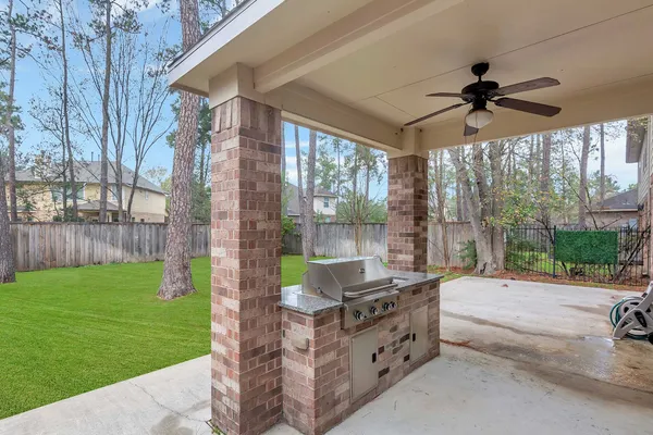 a backyard of a house with a garden and outdoor seating
