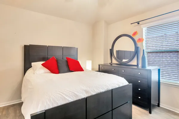 a bedroom with a bed and a dresser