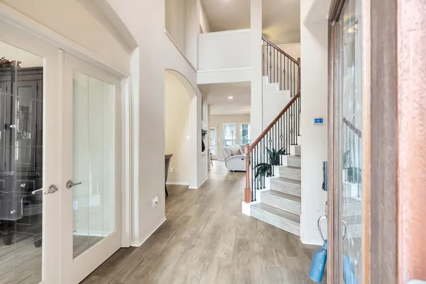 a view of entryway and hall with wooden floor