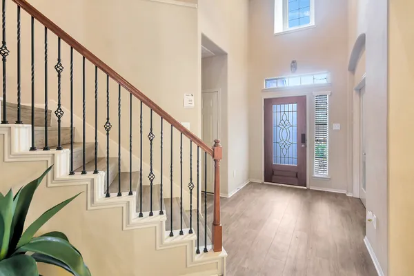 a view of staircase with railing and a wooden floor