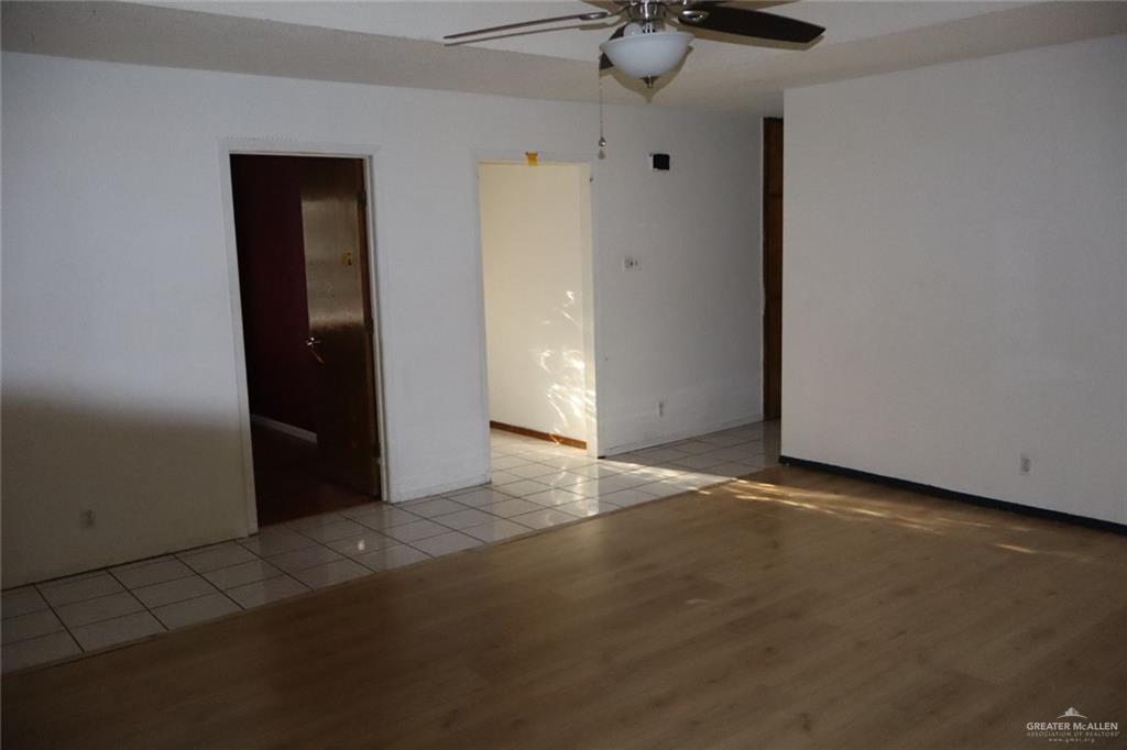 27 Las Palmas Road Zapata, TX 78076 - Photo 5 of 14 an empty room with a ceiling fan and carpet