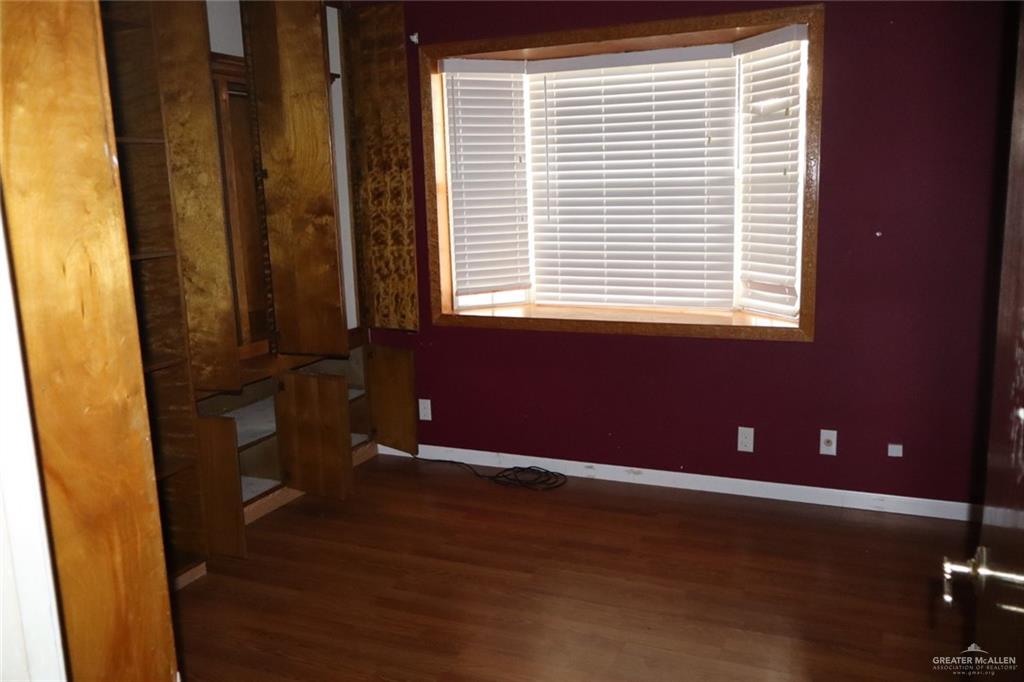27 Las Palmas Road Zapata, TX 78076 - Photo 6 of 14 a view of an empty room with wooden floor and a window