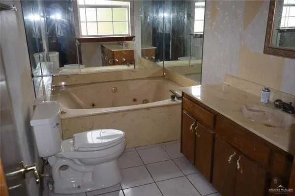 a bathroom with a sink a toilet and mirror