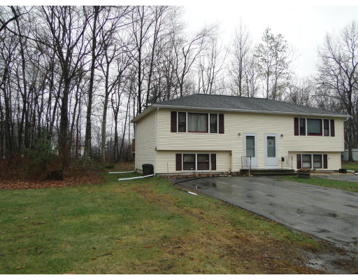 27 Derryfield Road, Unit L Derry, NH 03038 - Photo 1 of 1 a view of a yard in front of a house with large trees