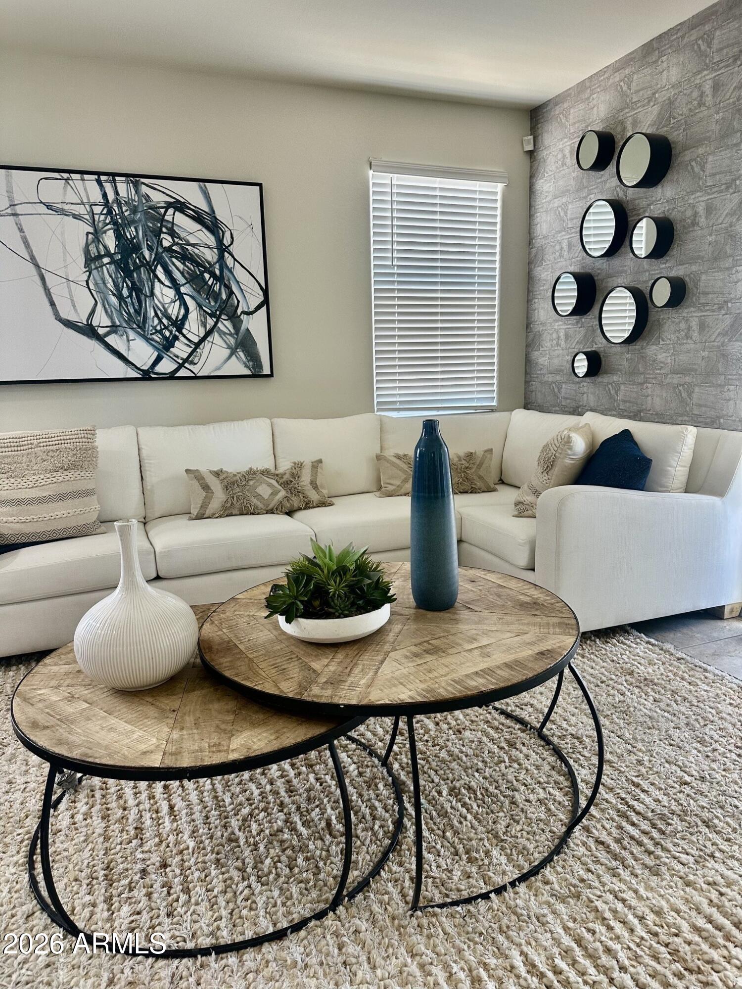 7851 West Riverside Avenue Phoenix, AZ 85043 - Photo 6 of 40 a living room with furniture a rug and a window